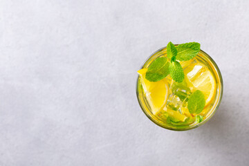 Lemonade, lemon, mint cocktail in glasses. Grey background. Copy space. Top view. © annapustynnikova