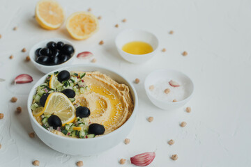 Hummus with olive oil, olives, lemon, garlic, sesame seeds, onions and cucumbers.