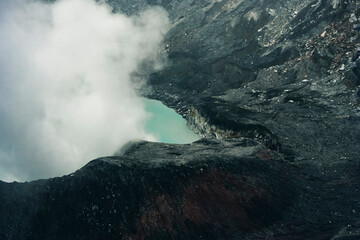 Crater Lake with smoke in Poas Volcano National Park, Costa Rica