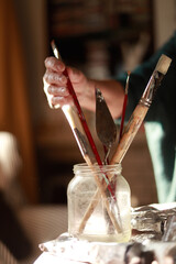 mano de artista cojiendo un pincel para pintar