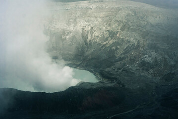 Crater Lake with smoke in Poas Volcano National Park