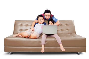 Young man helping his children to using a laptop