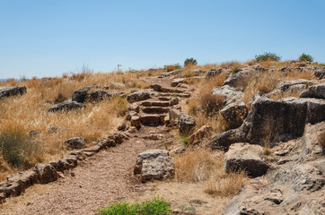 landscape in the mountains on a sunny day with a view from the mountain settlement of people and the lake