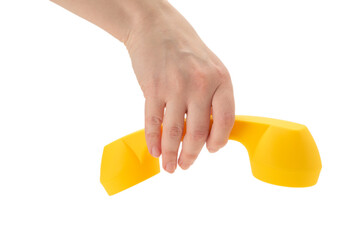 Yellow handset in woman hand isolated on white.