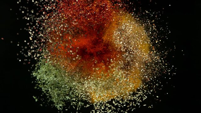 Super slow motion of flying spices mix on black background. Filmed on high speed cinema camera, 1000 fps