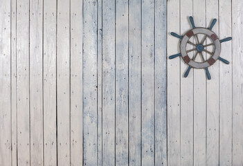 wooden steering wheel on white wooden background © serikbaib