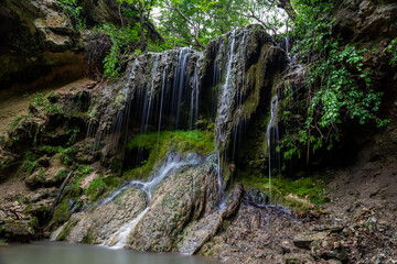 Fototapeta premium Beautiful waterfall with a lagoon for relaxation in the summer.