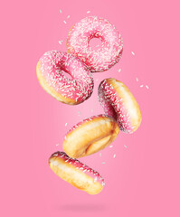 Donuts in the air on a pink background