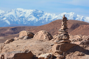Stone tower on the top of hill in Ajt Bin Haddu, with a view of atlas mountains in the background.