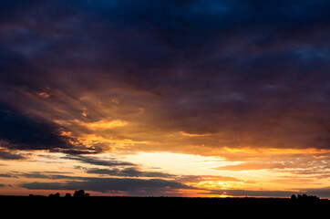 Sunset over agricultural field. Beautiful sunset