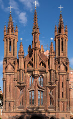 Fototapeta na wymiar The stunning St. Anne's Church in Vilnius Old Town, Lithuania. A prominent example of both Flamboyant Gothic and Brick Gothic styles and A UNESCO World heritage site.