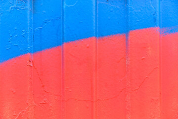 Metal siding painted in red and blue