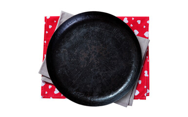 Empty round cast-iron pan for pizza with napkin isolated on white