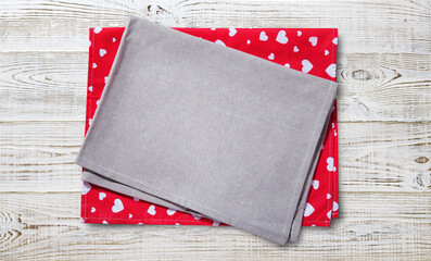 Fototapeta premium Red napkin. Stack of colorful dish towels on white desk