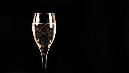 Expensive and luxurious vintage champagne with delicate bubbles in a wine glass on a black...