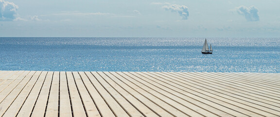 Banner Wooden background and sunny sea with boat