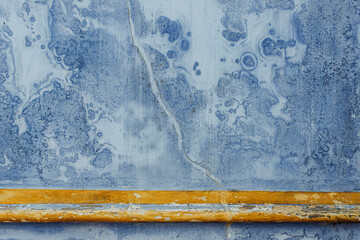 Texture of an old wall in Sintra, Portugal. Ancient blue wall and yellow decorative elements