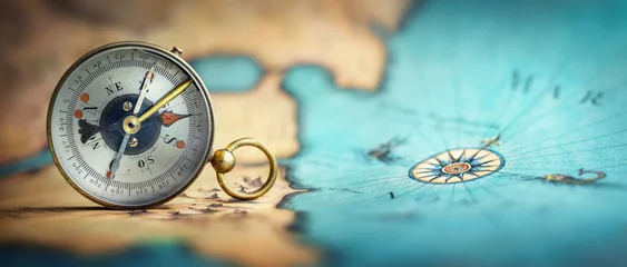 Foto op Plexiglas Magnetic old compass on world map.Travel, geography, navigation, tourism and exploration concept background. Macro photo. Very shallow focus. © Tryfonov