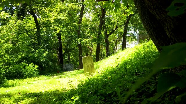Creepy grave in a haunted old overgrown abandoned cemetery