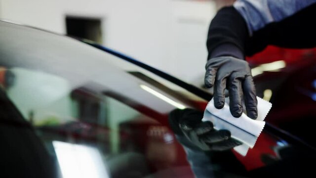 Rubbing ceramic coating on car windshield