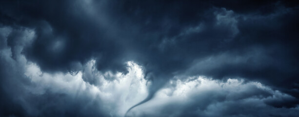 The typhoon is born, a tornado in a stormy dark sky with black clouds and a strong wind.  Concept...