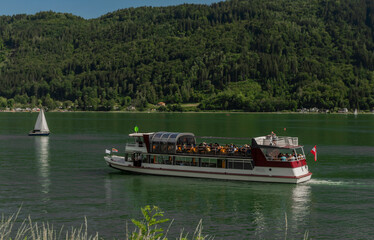 Obraz premium Passenger boat on Ossiacher see near Villach town in summer hot day