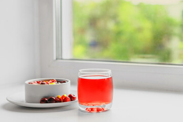 Fruit salad and juice near the window. Healthy breakfast concept.