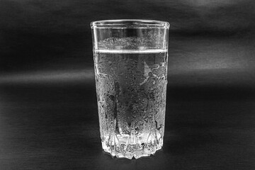 glass with cold water on a black background