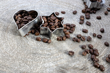 postcard template for Christmas with coffee beans filled into a cookie cutter on a grey wood slice,...