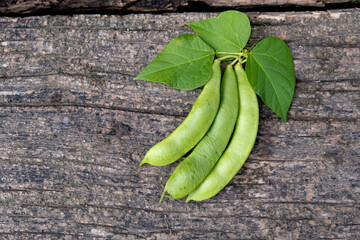 Raw green beans on wood background. Closeup.