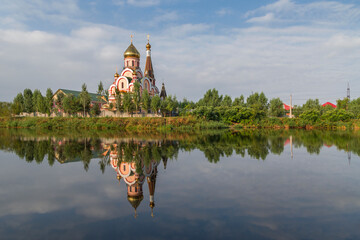 Russian orthodox church in Almaty, Kazakhstan known also as Church of Exaltation of the Holy cross, and its reflection in water.