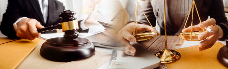 Justice and law concept.Male judge in a courtroom with the gavel, working with, computer and...