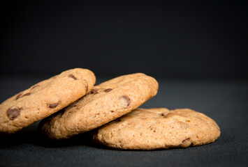 Chocolate chips cookies in a black background