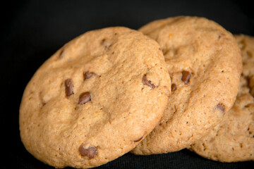 Chocolate chips cookies in a black background
