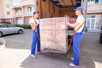 Loaders taking furniture from truck