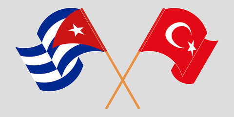Crossed and waving flags of Cuba and Turkey