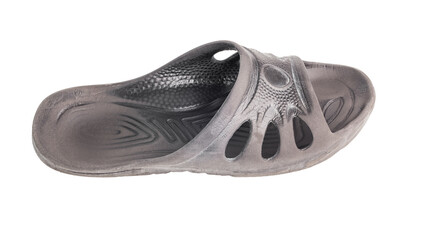 one used cheap black soft rubber slipper with signs of friction wear isolated on white background