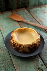 Homemade cheesecake on the old painted wood with wooden spatula
