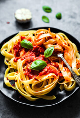 Tagliatelle pasta with arrabbiata sauce, basil, garlic, cherry tomatos