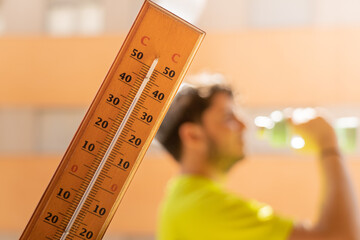 Man doing sport with hot weather and termometer temperature with hot temperature