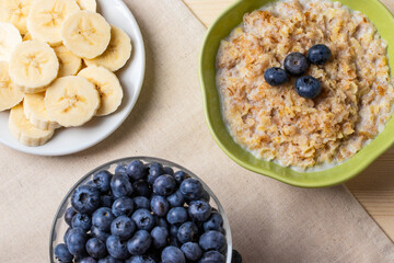 blueberries and porridge as morning healthy breakfast concept