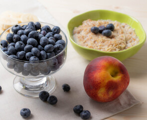 blueberries and porridge as morning healthy breakfast concept