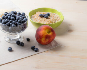 blueberries and porridge as morning healthy breakfast concept