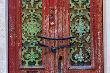 Cast iron decoration on the door of a closed house in Faro, Algarve, Portugal