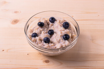 blueberries and porridge as morning healthy breakfast concept