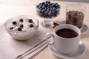 blueberries and porridge as morning healthy breakfast concept