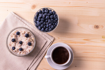 blueberries and porridge as morning healthy breakfast concept