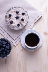 blueberries and porridge as morning healthy breakfast concept