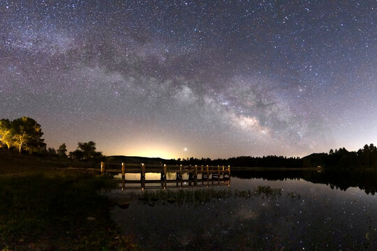 Milky way galaxy and wooden pier at Lake Cuyamaca in San Diego County, California