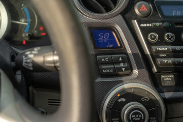 Fototapeta premium use air conditioner in car, climate control dashboard, switching temperature in vehicle